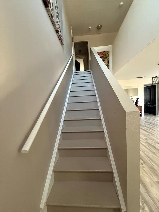 stairs featuring wood-type flooring