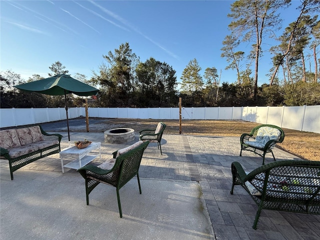 view of patio / terrace featuring an outdoor living space with a fire pit