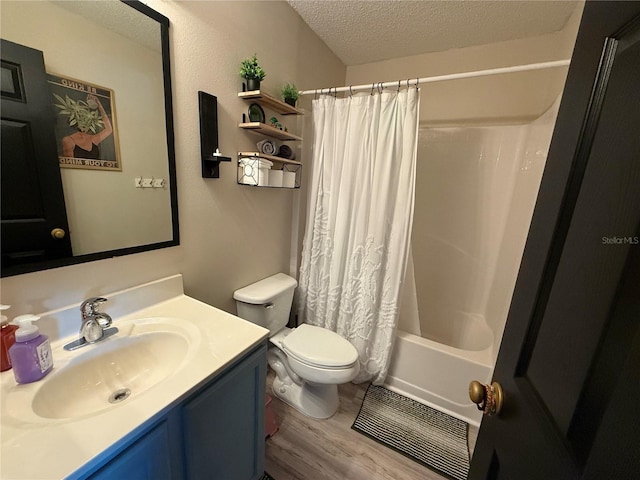 full bathroom with wood-type flooring, vanity, toilet, shower / bath combo, and a textured ceiling