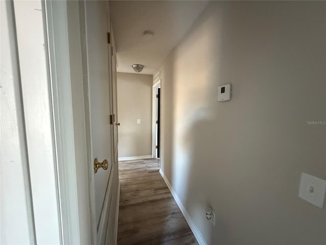 corridor with dark wood-type flooring