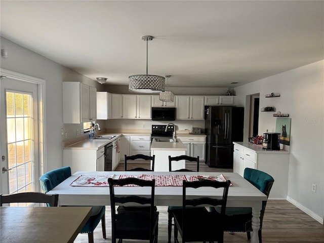 dining area featuring dark wood-type flooring and sink