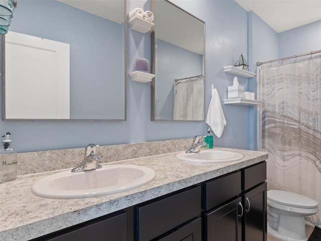 full bathroom featuring a sink, toilet, and double vanity