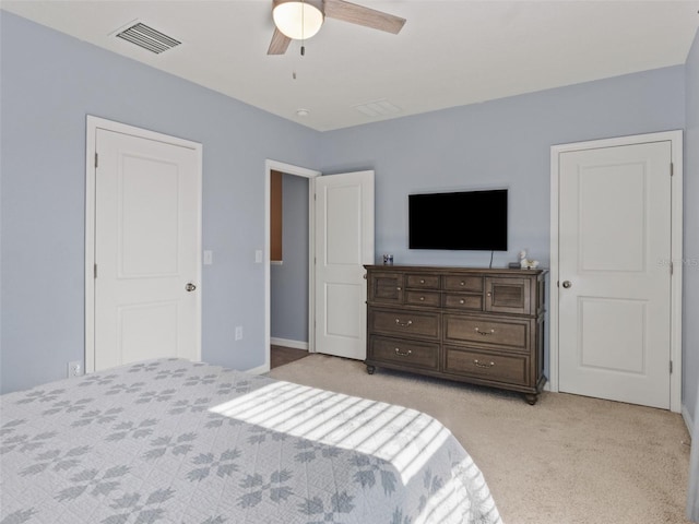 bedroom featuring light carpet, visible vents, and ceiling fan