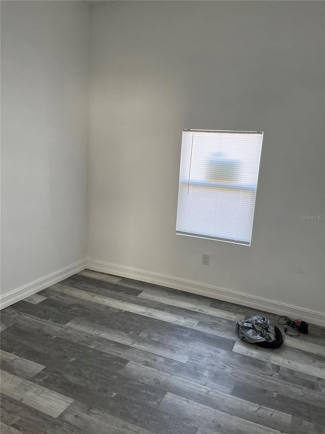 empty room with dark wood-type flooring