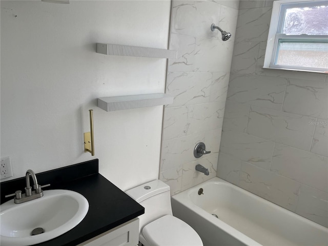 full bathroom with vanity, tiled shower / bath combo, and toilet