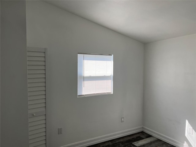 unfurnished room featuring dark wood-type flooring