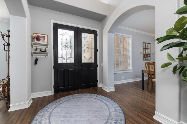 entrance foyer with crown molding and dark hardwood / wood-style flooring