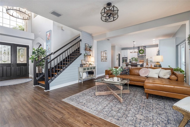 living room with an inviting chandelier and dark hardwood / wood-style flooring