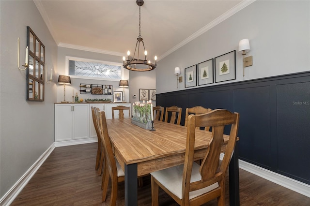 dining area featuring an inviting chandelier, ornamental molding, and dark hardwood / wood-style floors