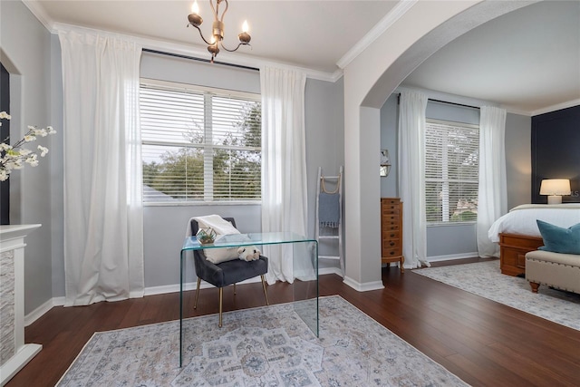 sitting room with crown molding, dark wood-type flooring, and a chandelier