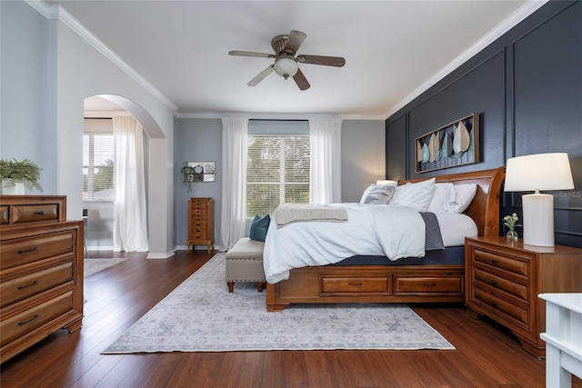 bedroom with dark wood-type flooring, ceiling fan, and crown molding