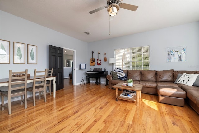 living room featuring light hardwood / wood-style flooring and ceiling fan