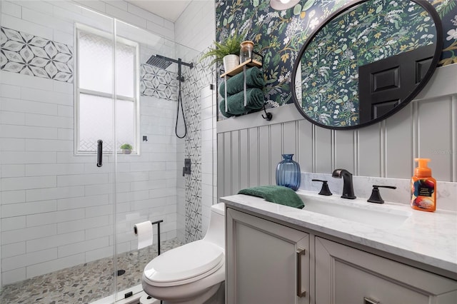 bathroom featuring vanity, an enclosed shower, and toilet