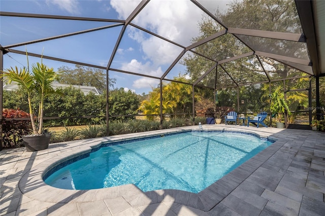 view of swimming pool with a patio and glass enclosure