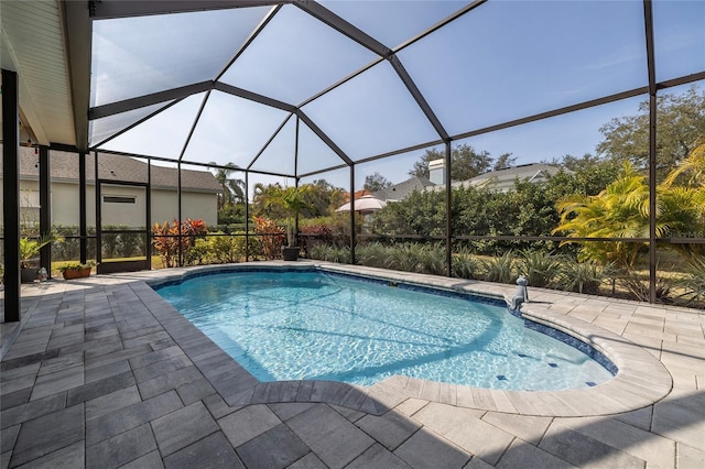 view of pool featuring a patio and glass enclosure