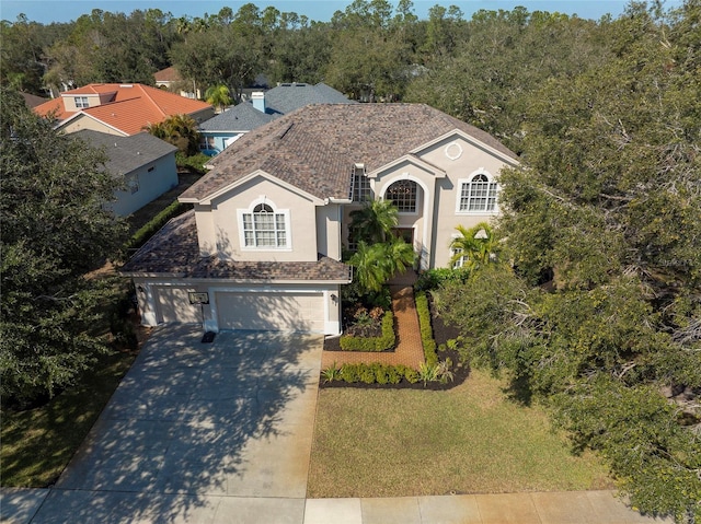 view of front of home with a garage and a front lawn