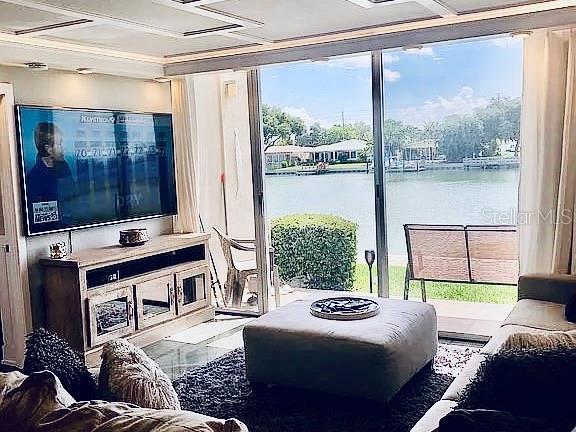 living room with a wall of windows and a water view