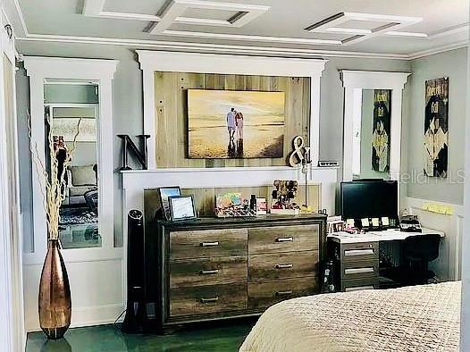 bedroom with dark hardwood / wood-style flooring and crown molding