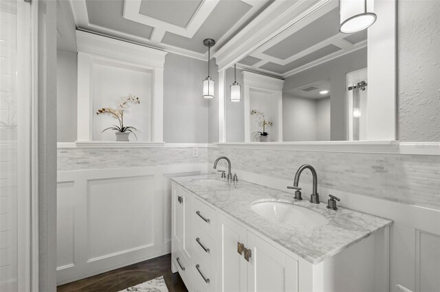 full bathroom with a sink, a wainscoted wall, double vanity, and a textured wall