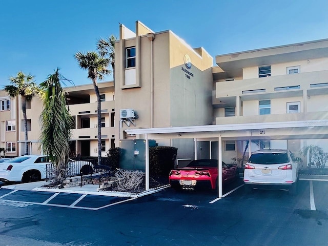 view of building exterior featuring covered parking