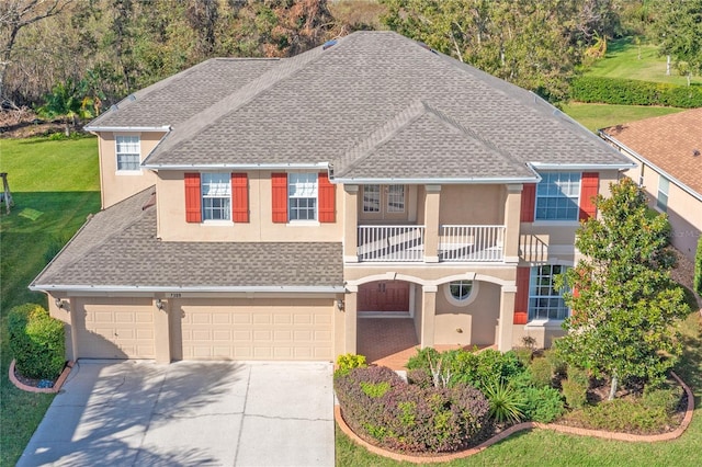 view of front of home with a balcony and a garage