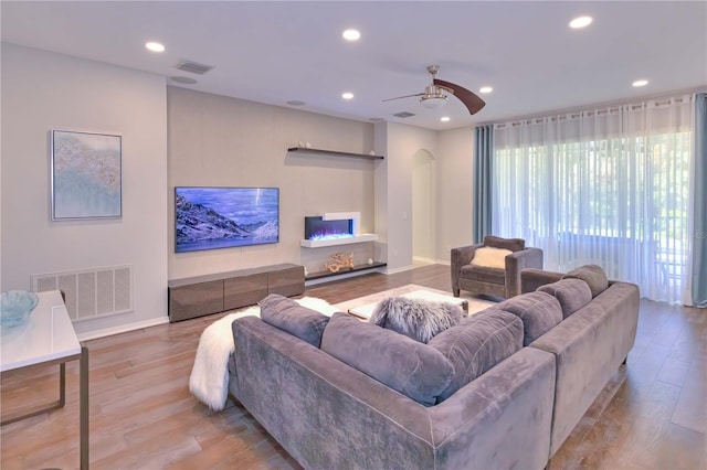 living room featuring ceiling fan and light wood-type flooring