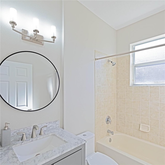 full bathroom featuring vanity, toilet, and tiled shower / bath combo