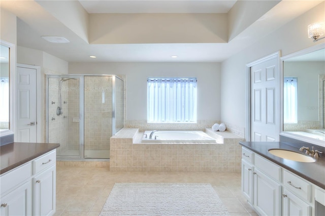 bathroom with tile patterned flooring, vanity, and independent shower and bath