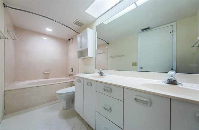 full bathroom with toilet, a skylight, shower / tub combination, vanity, and tile patterned flooring