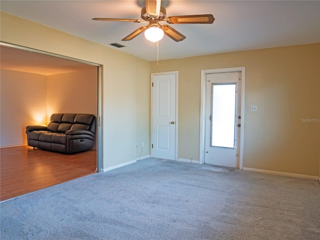 interior space with ceiling fan and carpet floors