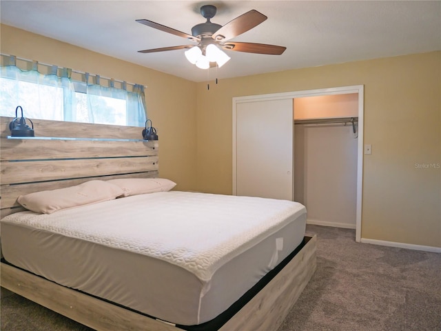 carpeted bedroom with ceiling fan and a closet