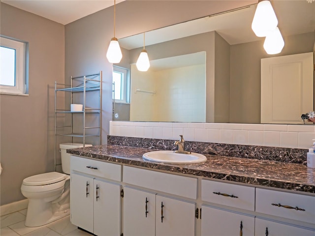 bathroom featuring vanity, tile patterned flooring, and toilet