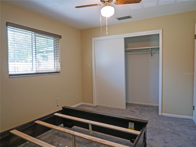 bedroom featuring ceiling fan, carpet, and a closet