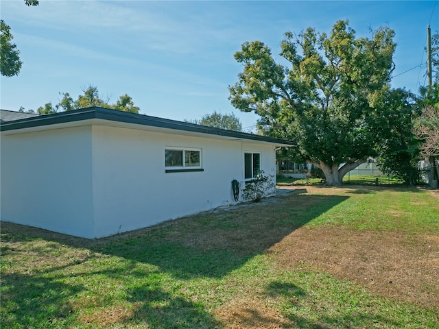 view of home's exterior with a yard