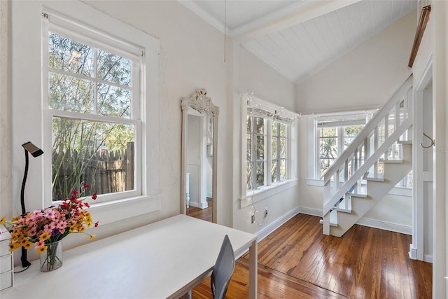 dining space with lofted ceiling with beams and dark wood-type flooring