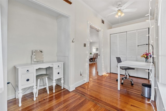 office area featuring hardwood / wood-style flooring, ornamental molding, and ceiling fan