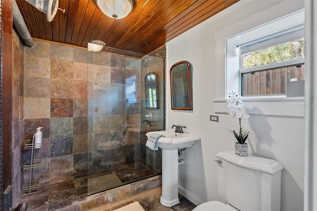 bathroom featuring wood ceiling, toilet, and tiled shower