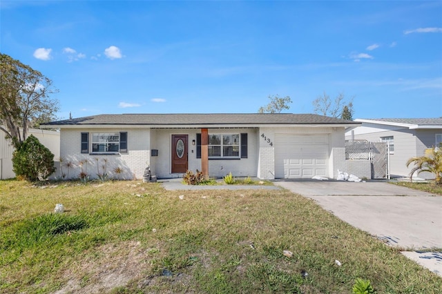 ranch-style house featuring a garage and a front lawn