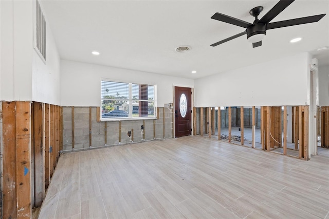 foyer with ceiling fan and light hardwood / wood-style floors