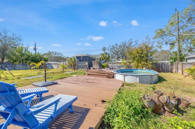 wooden terrace featuring a fenced in pool and a lawn