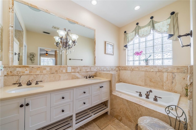 bathroom with vanity, plenty of natural light, a relaxing tiled tub, and tile walls