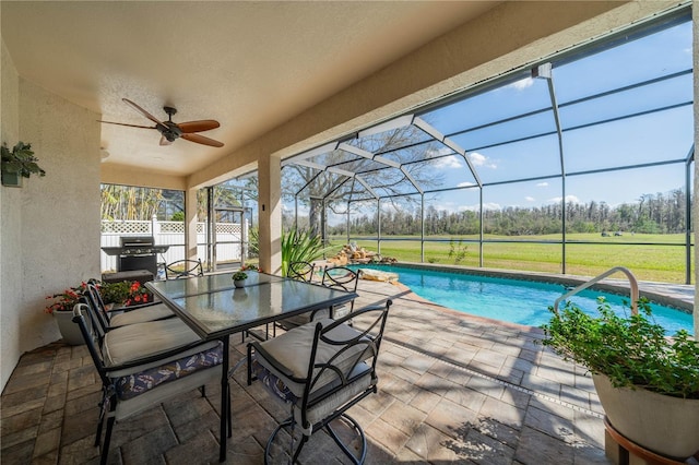 view of pool featuring a lanai, grilling area, a patio, and ceiling fan