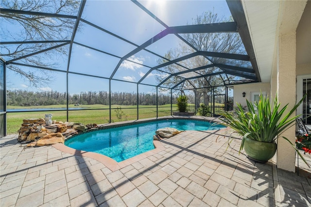 view of pool with a lanai, a patio, and a lawn