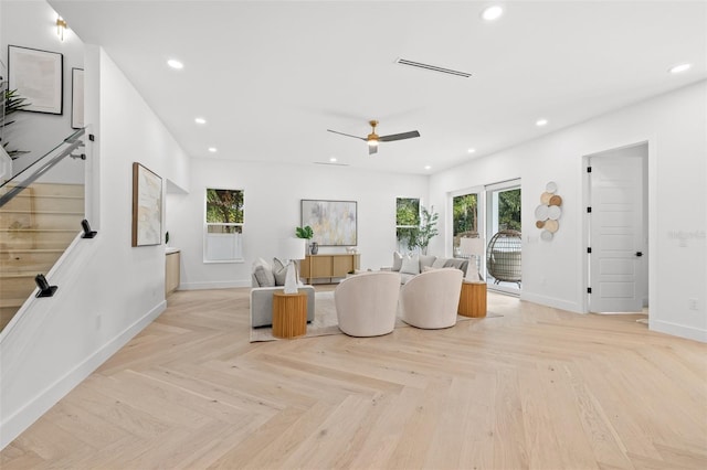 living room featuring ceiling fan and light parquet floors