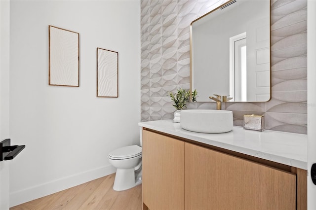 bathroom with vanity, hardwood / wood-style floors, and toilet