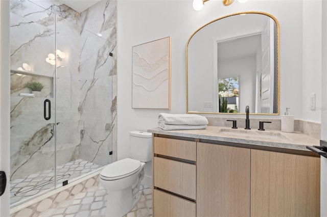 bathroom with vanity, toilet, and walk in shower