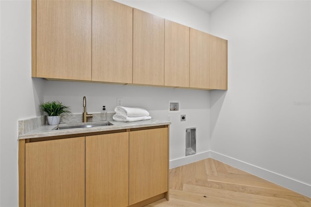 laundry room with sink, light parquet floors, cabinets, washer hookup, and hookup for an electric dryer