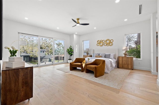 bedroom featuring ceiling fan, light hardwood / wood-style flooring, and access to outside