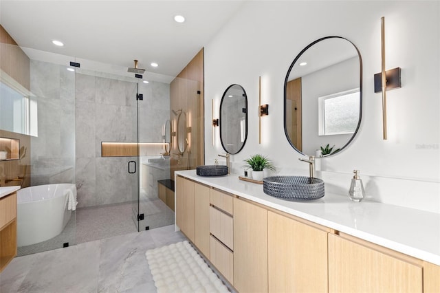 bathroom featuring vanity and separate shower and tub