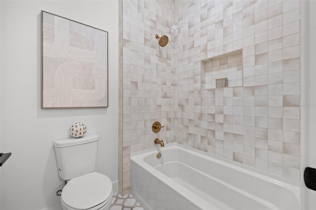 bathroom with tiled shower / bath combo and toilet